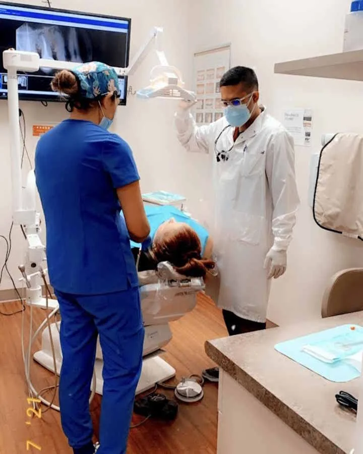 Dental care team beside a treatment chair, illustrating the office setting for hygienist care in Pasadena